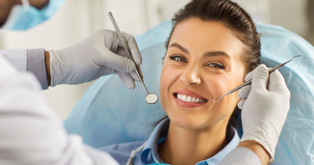 Happy woman in Los Altos, CA, with a dentist examining her teeth for dental bridgeS treatment